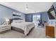 Stylish main bedroom featuring blue walls, fan, and access to a balcony at 11009 Pentland Downs St, Las Vegas, NV 89141