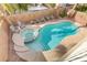 A backyard pool features a spa, lounge chairs, privacy wall, and manicured landscaping at 11009 Pentland Downs St, Las Vegas, NV 89141