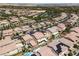 An aerial view of a community featuring two-story homes, desert landscaping, and multiple community tennis courts at 12296 Kings Eagle St, Las Vegas, NV 89141