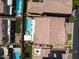 An aerial view reveals backyard oasis with pool, turf, covered patio, and outdoor seating in a desert setting at 12296 Kings Eagle St, Las Vegas, NV 89141
