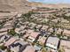 An aerial view shows homes in a desert community with two-story homes, some featuring pools, in a mountain setting at 12296 Kings Eagle St, Las Vegas, NV 89141