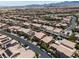 A desert community aerial view featuring two-story homes, desert landscaping, backyard pools and many solar panels at 12296 Kings Eagle St, Las Vegas, NV 89141