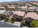 Beautiful neighborhood view of the home with a tile roof, solar panels, and lush landscaping at 12296 Kings Eagle St, Las Vegas, NV 89141