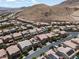 Desert homes are pictured in an aerial view, showing two-story homes, many with backyard pools and desert surroundings at 12296 Kings Eagle St, Las Vegas, NV 89141