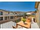 Charming balcony featuring a table and chairs, perfect for enjoying views of the surrounding neighborhood and mountains in the distance at 12296 Kings Eagle St, Las Vegas, NV 89141