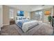 Inviting bedroom featuring a large bed, cool tones, and ample natural light at 12296 Kings Eagle St, Las Vegas, NV 89141
