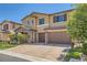 Inviting two-story home featuring stone accents, a brick driveway, and a two-car garage at 12296 Kings Eagle St, Las Vegas, NV 89141