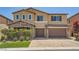 Well-maintained home featuring a brick driveway, stone accents, and a two-car garage at 12296 Kings Eagle St, Las Vegas, NV 89141