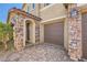 Charming house featuring stone accents on the garage and porch, and a brick driveway at 12296 Kings Eagle St, Las Vegas, NV 89141