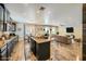 Open kitchen and living area with hardwood floors, granite counters, and stainless appliances at 12296 Kings Eagle St, Las Vegas, NV 89141