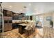 Bright kitchen boasts stainless steel appliances, dark cabinetry, and granite countertops at 12296 Kings Eagle St, Las Vegas, NV 89141