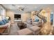Spacious living room with hardwood floors and staircase featuring a fireplace at 12296 Kings Eagle St, Las Vegas, NV 89141