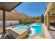 Inviting backyard pool and spa with lush landscaping and a brick perimeter, perfect for relaxation and entertaining at 12296 Kings Eagle St, Las Vegas, NV 89141