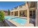 A refreshing backyard pool with a built-in spa and outdoor kitchen area of this two story home at 12296 Kings Eagle St, Las Vegas, NV 89141
