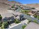 Stunning aerial view of a neighborhood with gorgeous homes near the mountains and paved streets at 12705 Coastline Shadow St, Las Vegas, NV 89141