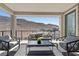 Relaxing balcony with comfortable seating, a coffee table, and scenic mountain views at 12705 Coastline Shadow St, Las Vegas, NV 89141