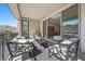Charming balcony with cozy seating area and sliding glass doors connecting to the home's interior at 12705 Coastline Shadow St, Las Vegas, NV 89141
