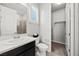 Bright bathroom featuring a walk-in shower, toilet and vanity with sink at 12705 Coastline Shadow St, Las Vegas, NV 89141