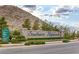 Beautiful stone Southern Highlands community entrance sign surrounded by lush greenery and landscaping at 12705 Coastline Shadow St, Las Vegas, NV 89141