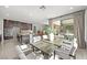 Open-concept dining area seamlessly connects to the modern kitchen, island, and living spaces at 12705 Coastline Shadow St, Las Vegas, NV 89141
