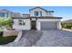 Charming two-story home featuring a beautiful paver driveway and attached two-car garage at 12705 Coastline Shadow St, Las Vegas, NV 89141