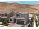 Beautiful home featuring a tile roof, desert landscaping, and mountain views at 12705 Coastline Shadow St, Las Vegas, NV 89141