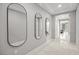 Bright foyer with stylish mirrors, tile flooring, and an inviting open floor plan at 12705 Coastline Shadow St, Las Vegas, NV 89141