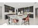 Modern kitchen featuring granite countertops, custom cabinetry, and a stylish island at 12705 Coastline Shadow St, Las Vegas, NV 89141