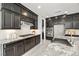Modern kitchen featuring stainless steel appliances, granite countertops, and elegant dark wood cabinets at 12705 Coastline Shadow St, Las Vegas, NV 89141