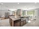 Bright, open-concept living area with large island, stainless appliances, and seamless indoor-outdoor flow at 12705 Coastline Shadow St, Las Vegas, NV 89141