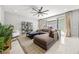 Comfortable living room with stylish decor, including a sectional sofa and shelving unit at 12705 Coastline Shadow St, Las Vegas, NV 89141