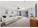 Bright, open living room with plush white sectional sofa and sliding glass doors to a balcony at 12705 Coastline Shadow St, Las Vegas, NV 89141