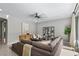 Well-decorated living room with a plush sofa, modern furniture, and a sliding glass door at 12705 Coastline Shadow St, Las Vegas, NV 89141
