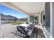 Covered patio with an outdoor dining set and scenic views at 12705 Coastline Shadow St, Las Vegas, NV 89141