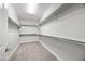 Empty walk-in closet featuring neutral carpeting and white closet shelving ready for organizing clothes and personal items at 12705 Coastline Shadow St, Las Vegas, NV 89141