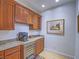 Stylish bar area featuring granite countertops, custom cabinets, wine storage, and a beverage refrigerator at 15 Avenza Dr, Henderson, NV 89011