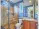 Beautiful bathroom featuring a glass-enclosed shower, granite countertop, and ample natural light at 15 Avenza Dr, Henderson, NV 89011