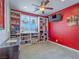 Cozy bedroom featuring a ceiling fan, built-in shelves, and a television for comfortable living at 15 Avenza Dr, Henderson, NV 89011