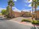 Beautiful home with a brick driveway, two-car garage, stone accents, and mature landscaping at 15 Avenza Dr, Henderson, NV 89011