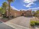 Charming home with a well-kept brick driveway, lush landscaping, and beautiful stone accents at 15 Avenza Dr, Henderson, NV 89011