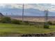 Expansive view of a golf course with the city skyline, mountain views, and power lines at 15 Avenza Dr, Henderson, NV 89011