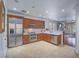 Spacious kitchen with stainless steel appliances, wooden cabinets, and tile flooring at 15 Avenza Dr, Henderson, NV 89011