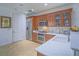Well-lit kitchen with granite countertops, stainless steel appliances, and wood cabinetry at 15 Avenza Dr, Henderson, NV 89011