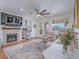 Bright living room with a fireplace, built-in desk, ceiling fan, and lots of natural light at 15 Avenza Dr, Henderson, NV 89011