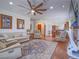 Inviting living room featuring hardwood floors, a ceiling fan, and comfortable seating arrangements at 15 Avenza Dr, Henderson, NV 89011