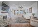 Spacious living room with wood floors, large area rug, comfortable seating, and fireplace at 15 Avenza Dr, Henderson, NV 89011
