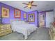 Purple-toned main bedroom with a ceiling fan, framed wall art, and classic furnishings at 15 Avenza Dr, Henderson, NV 89011