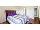 Comfortable bedroom featuring a wooden headboard and a stylish striped bedspread with purple pillows at 1605 Crimson Hills Dr # 204, Las Vegas, NV 89128