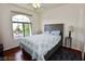 Bedroom featuring a ceiling fan, large window, and light color scheme at 1605 Crimson Hills Dr # 204, Las Vegas, NV 89128
