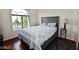 Bright bedroom featuring a large window, hardwood floors, and stylish furnishings at 1605 Crimson Hills Dr # 204, Las Vegas, NV 89128